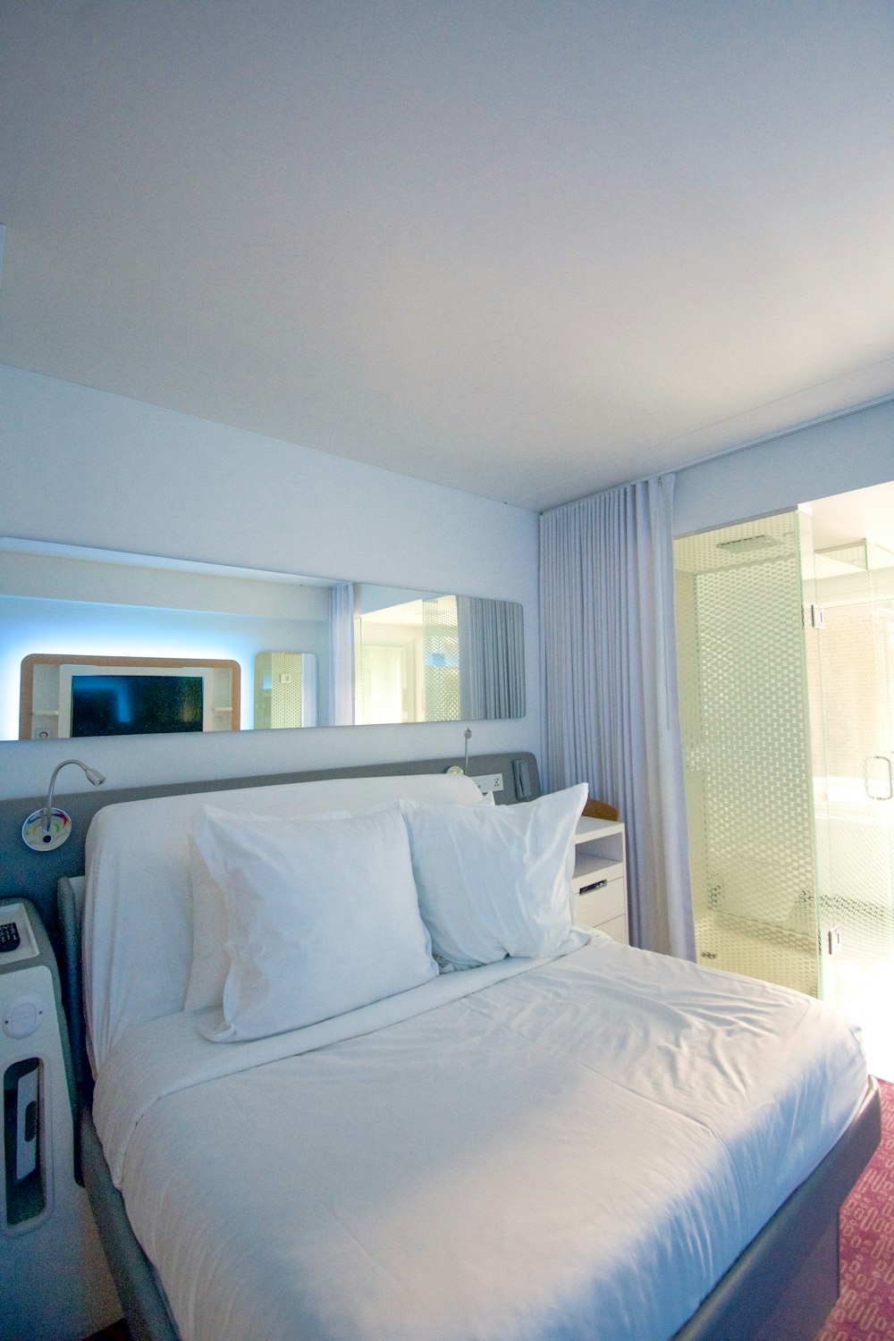 A made bed in a calm, modern bedroom